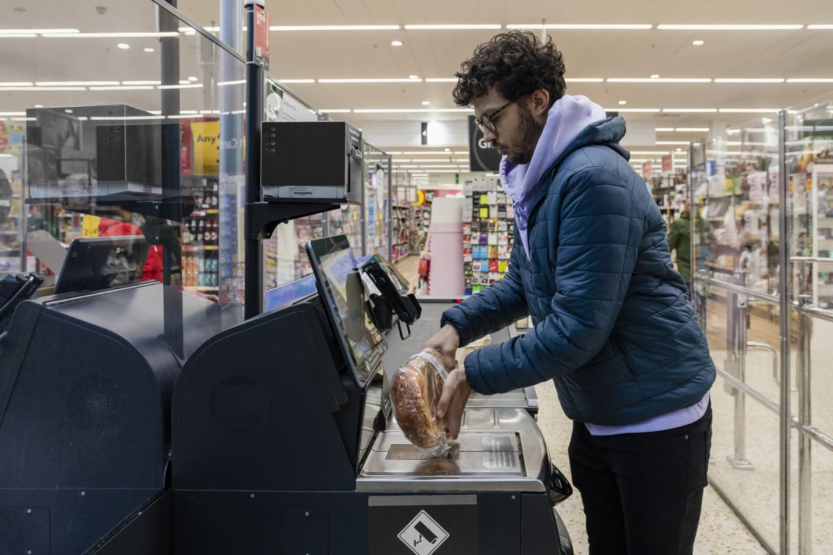 WASHINGTON, DC - DECEMBER, 21: Christina Ford, out of work for more than a year and living in a homeless shelter with her children is now working in the self checkout registers at a new Walmart in Washington, DC, Saturday December 21, 2013.   (Photo by Dayna Smith/For The Washington Post via Getty Images)