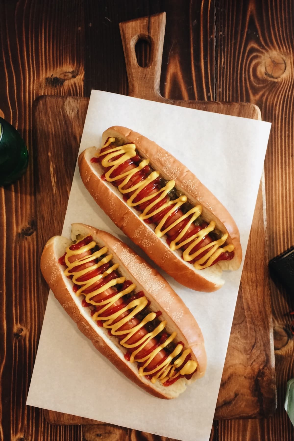Variety of hot dogs with ketchup and mustard on parchment paper