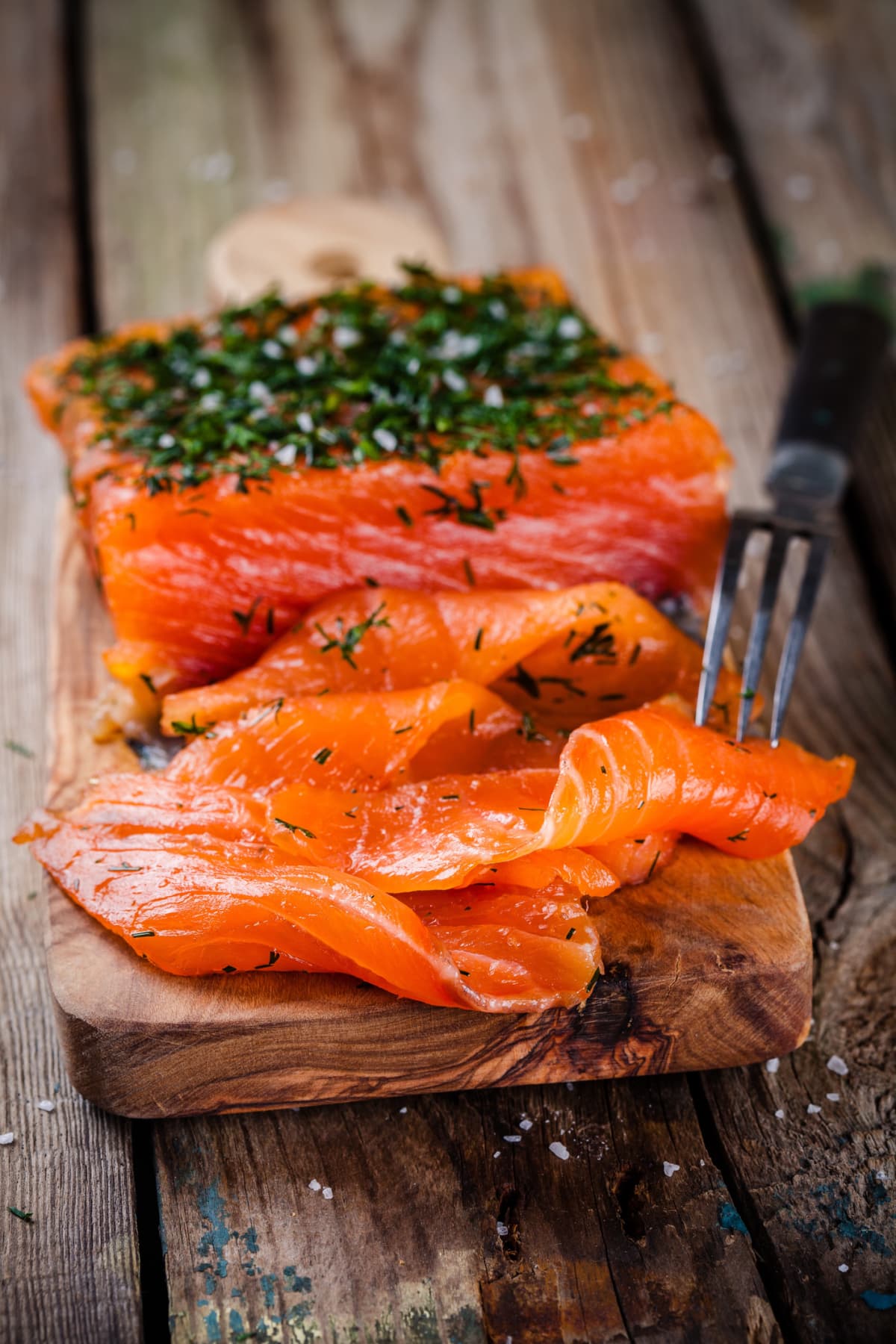 homemade smoked salmon with dill on a wooden table
