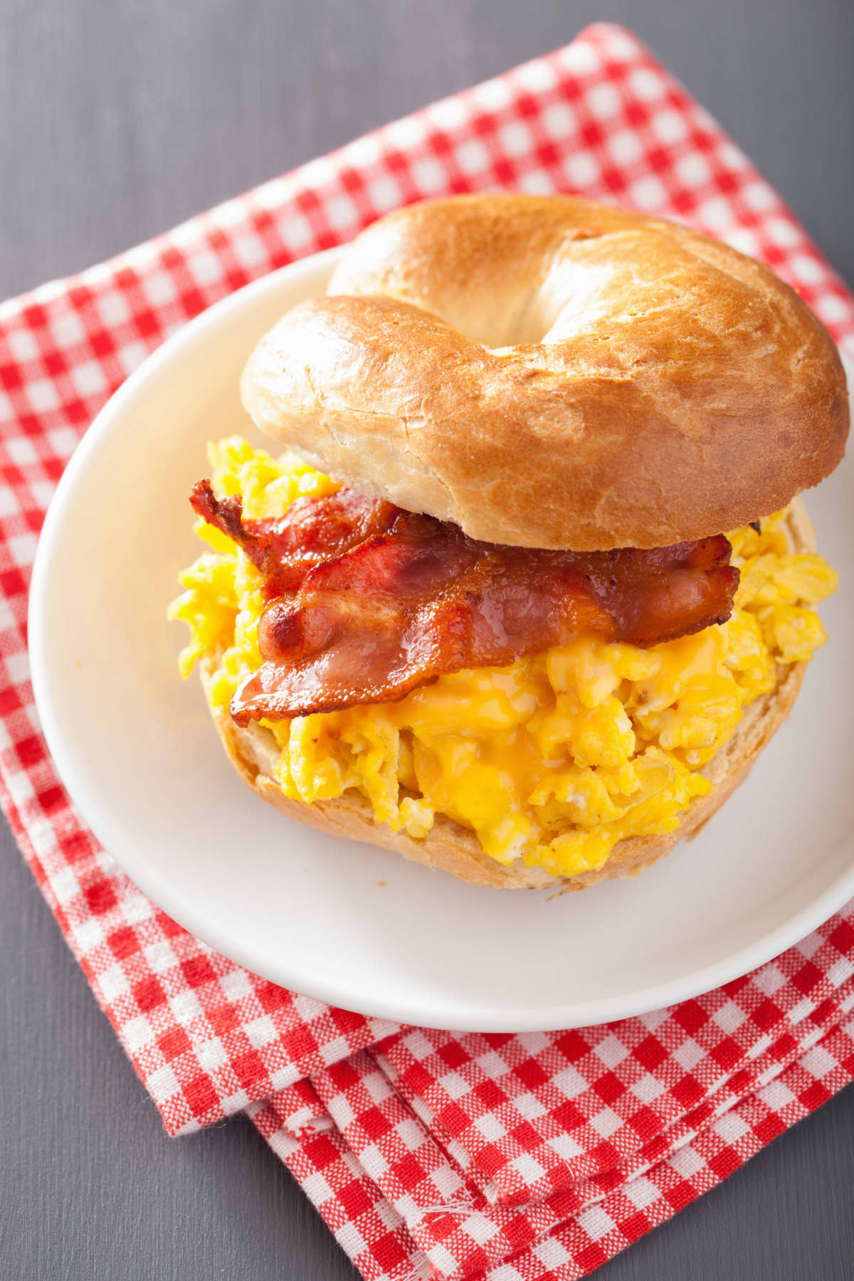 close up of rustic bacon egg breakfast sandwich bun