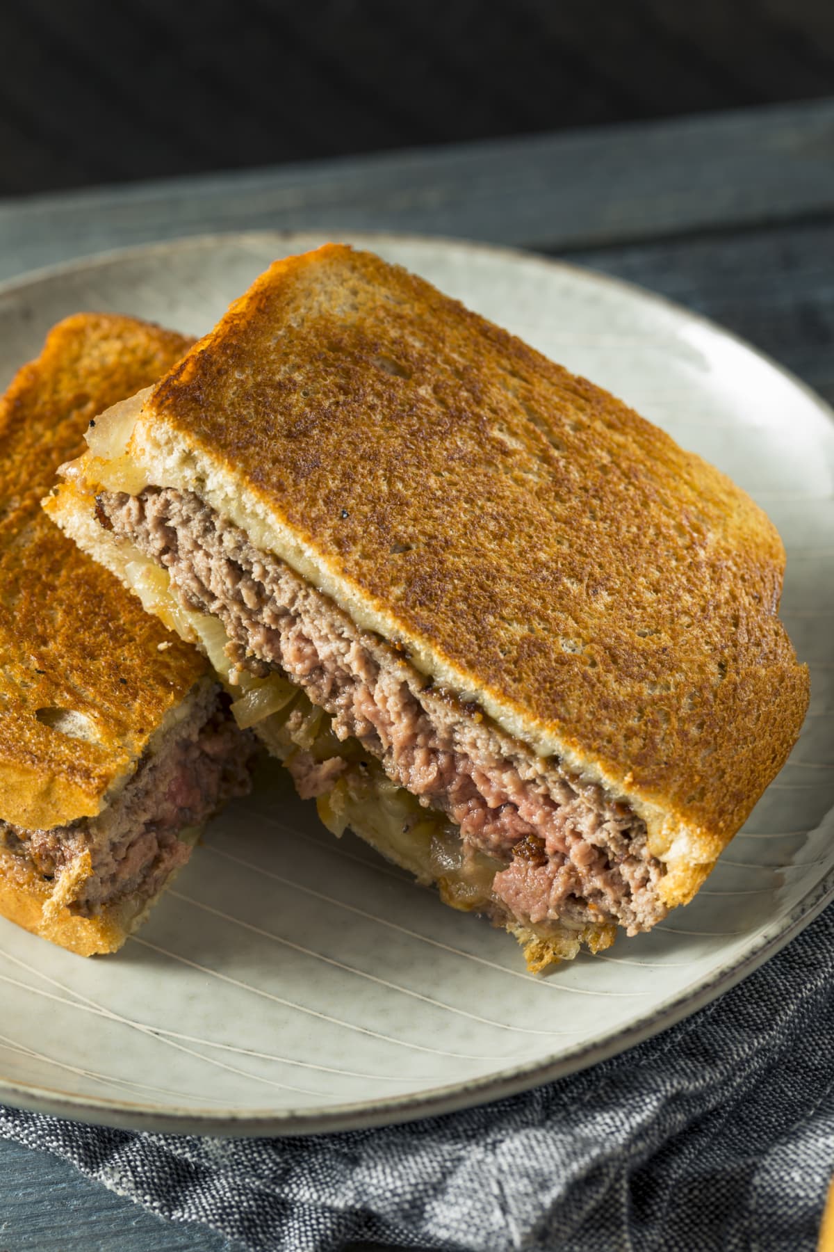 Homemade cheesy patty melt sandwich with cheese and onions