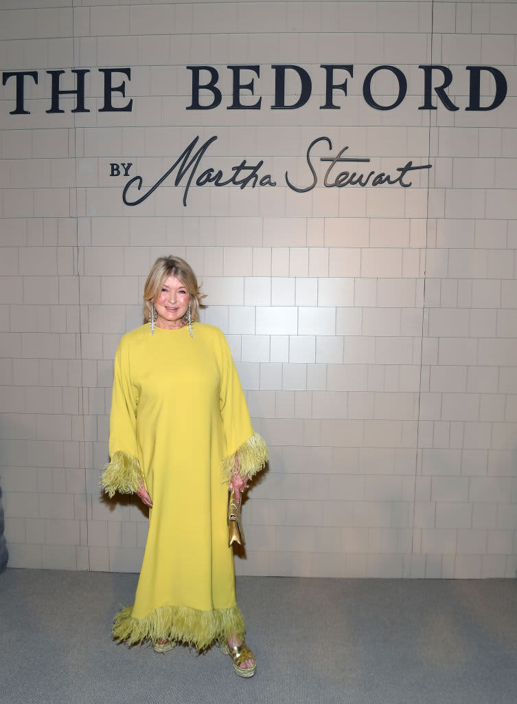 Martha Stewart in a yellow dress smiling