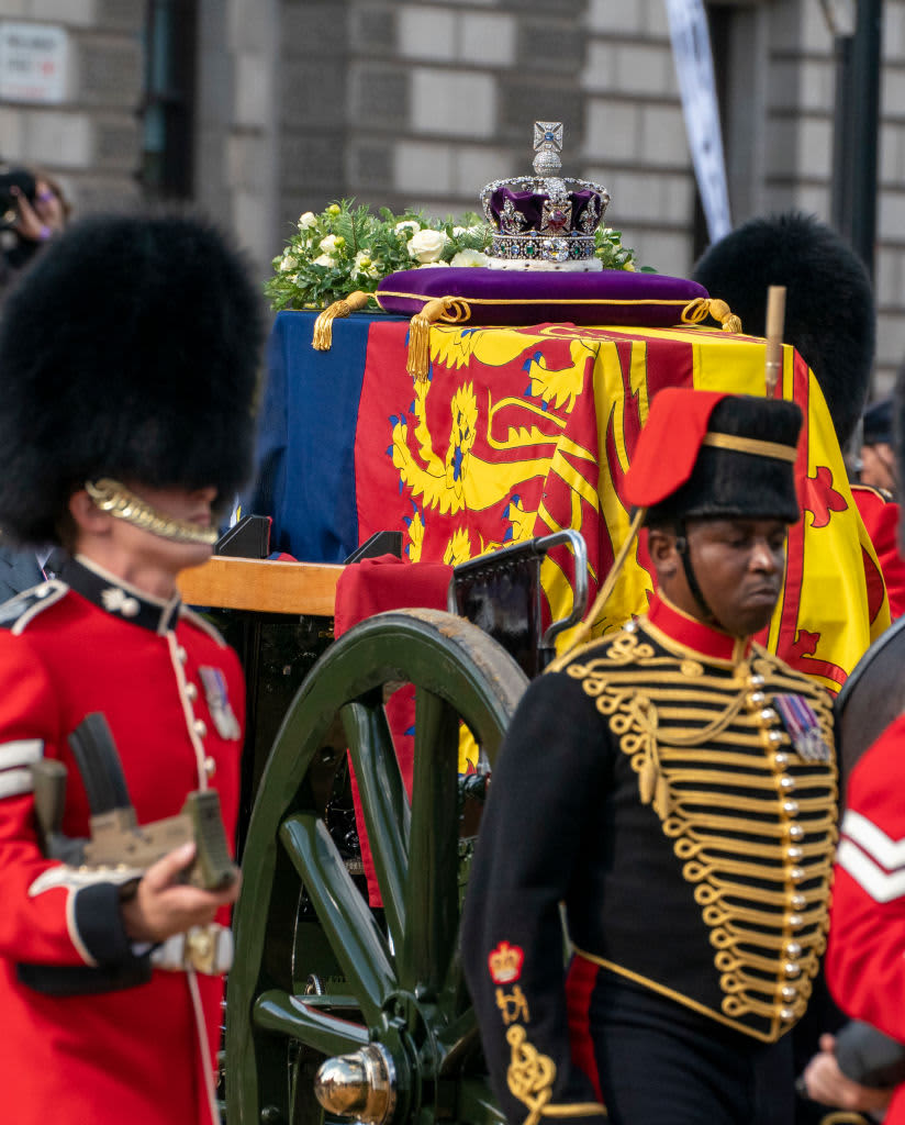 The State Gun Carriage carries the coffin of Queen Elizabeth II, draped in the Royal Standard with the Imperial State Crown and the Sovereign's orb and sceptre, in the Ceremonial Procession following her State Funeral at Westminster Abbey, in London on September 19, 2022. (Photo by Zac Goodwin / POOL / AFP) (Photo by ZAC GOODWIN/POOL/AFP via Getty Images)