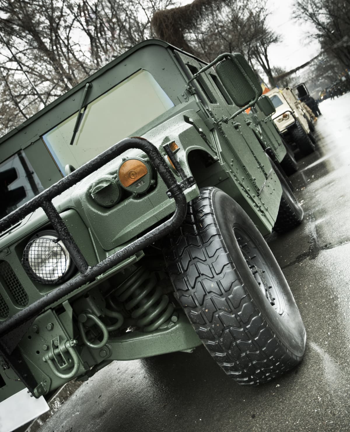Close up view of an armored HMMWV parked in a convoy row. The picture was taken on an icy rainy day. War Concept. Here are some other about cars editorial photos: