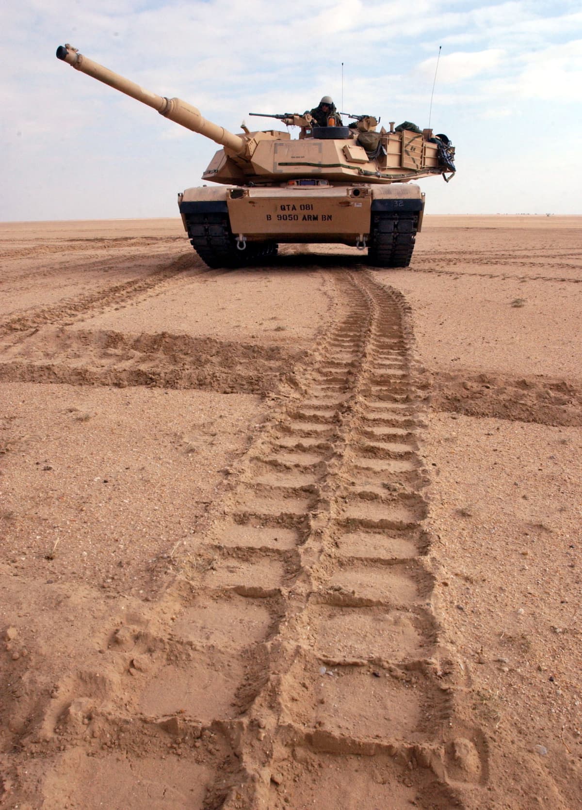 NEAR IRAQI BORDER IN KUWAIT - DECEMBER 18:  A U.S. Army M1/A1 Abrams tank from Charlie company of the 464 Armored Battalion changes position during task force manuevers December 18, 2002 near the Iraqi border in the Kuwaiti. The U.S. military continues to train throughout the gulf region in case of possible deployment to Iraq.  (Photo by Scott Nelson/Getty Images)