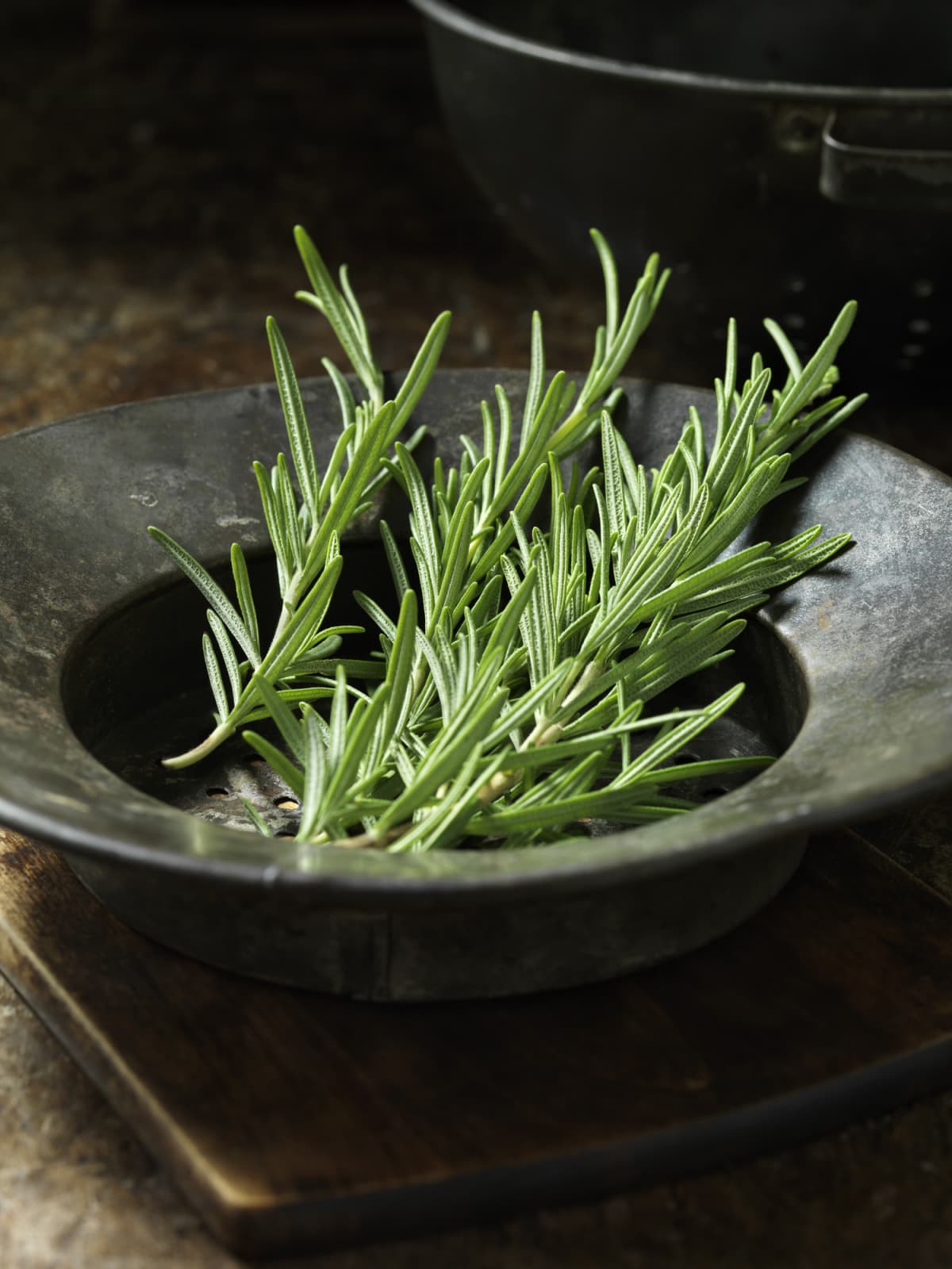 Rosemary sprigs in a black bowl 