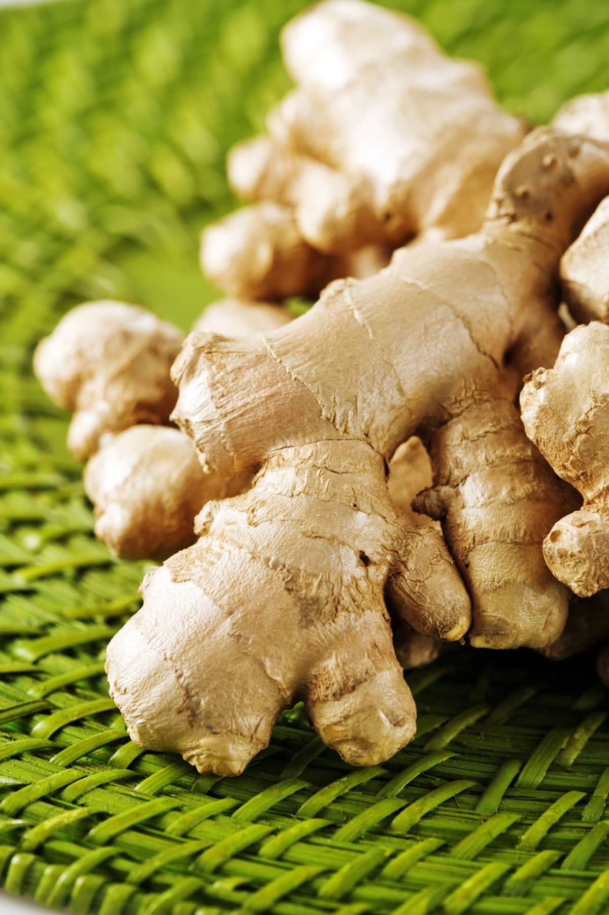 Piles of ginger roots on green placemat