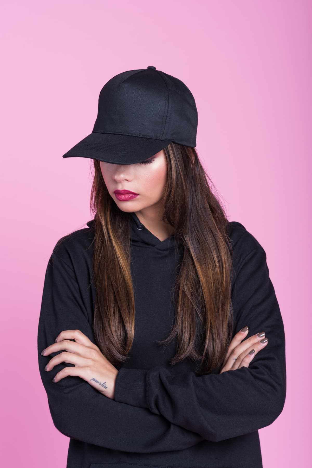 Studio portrait of a young woman wearing a laser cap disguised as a baseball cap