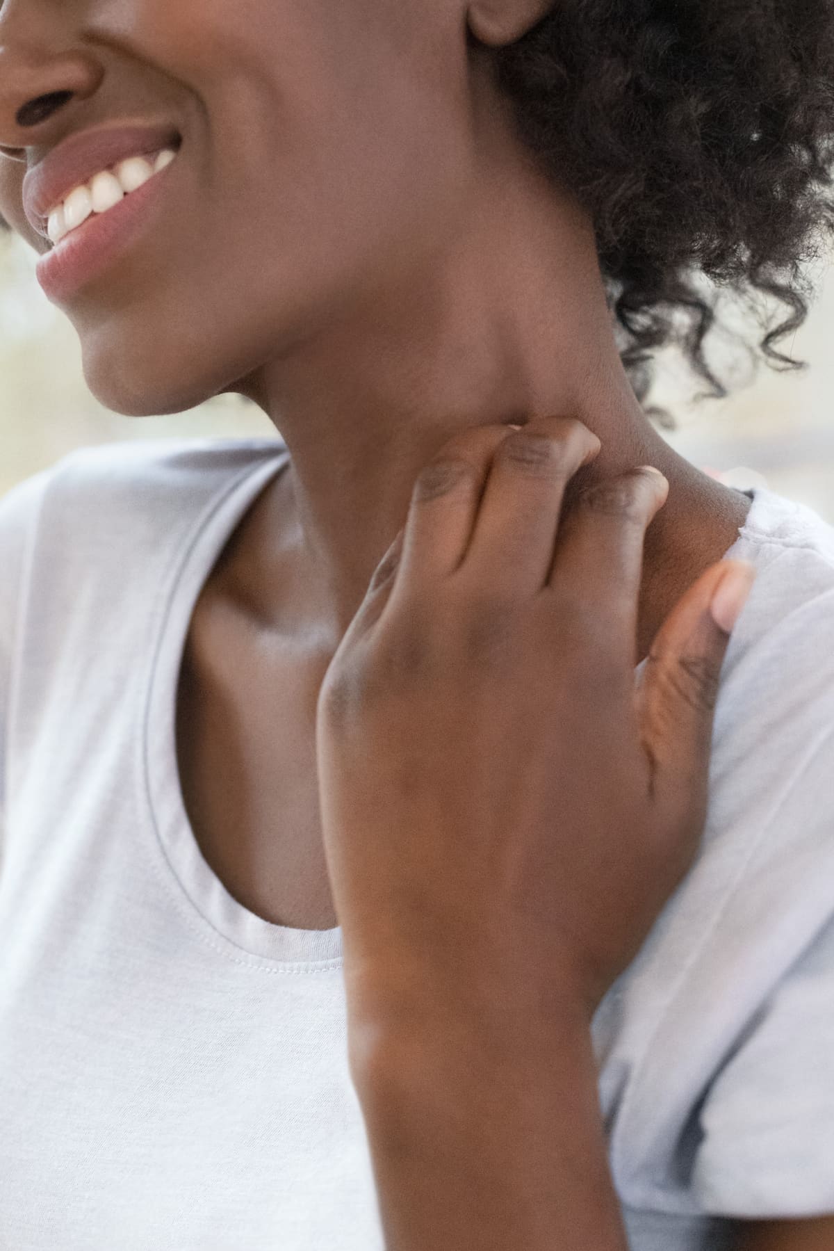 Woman scratching her neck.