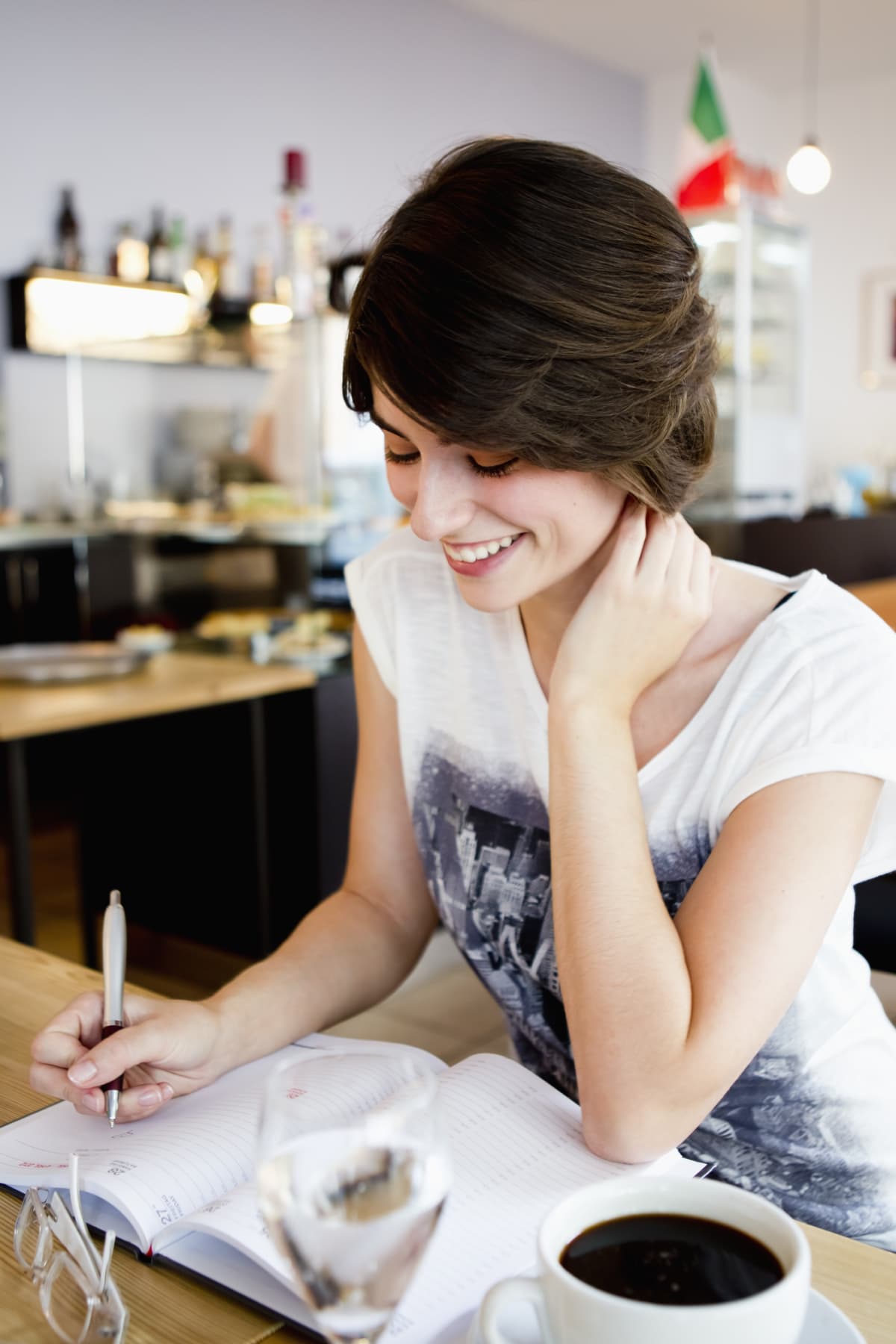 Woman writing affirmations in her journal to manifest her desires