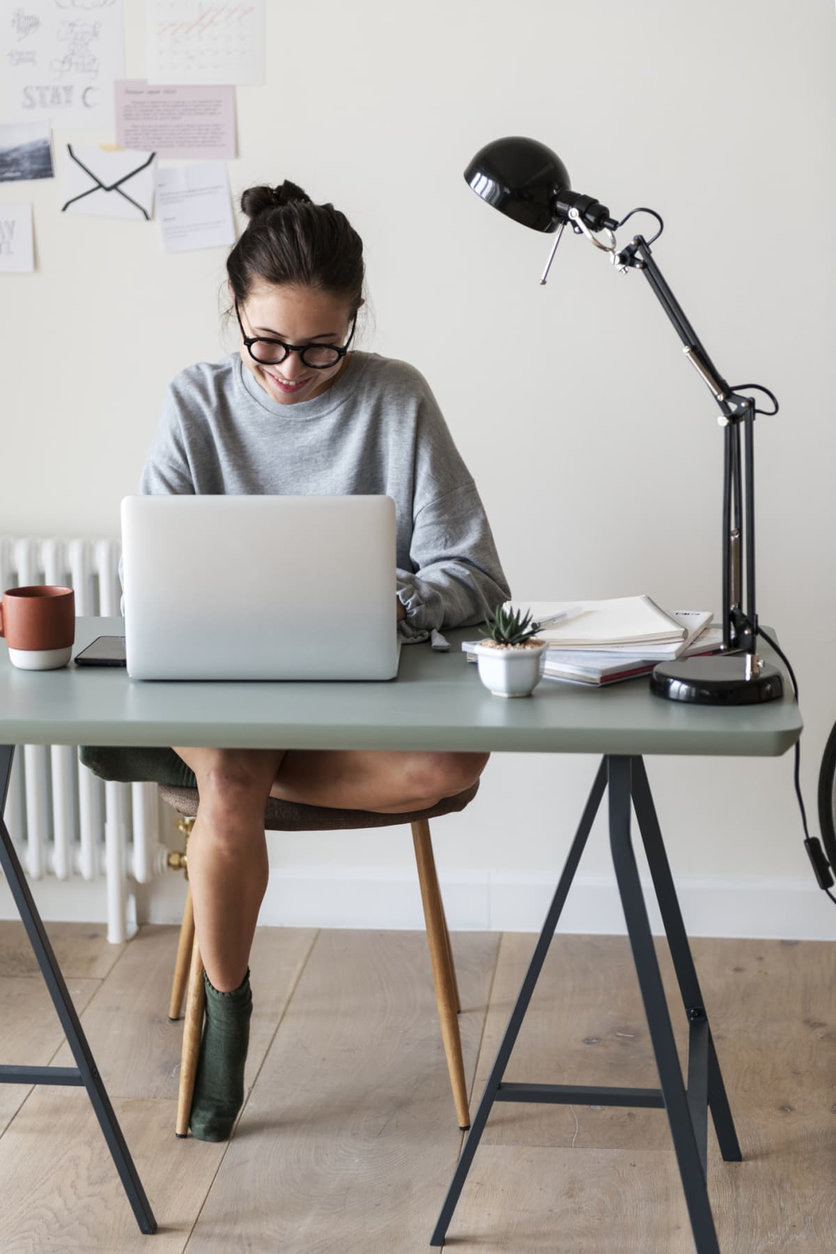 Woman works from home in a sweatshirt and socks