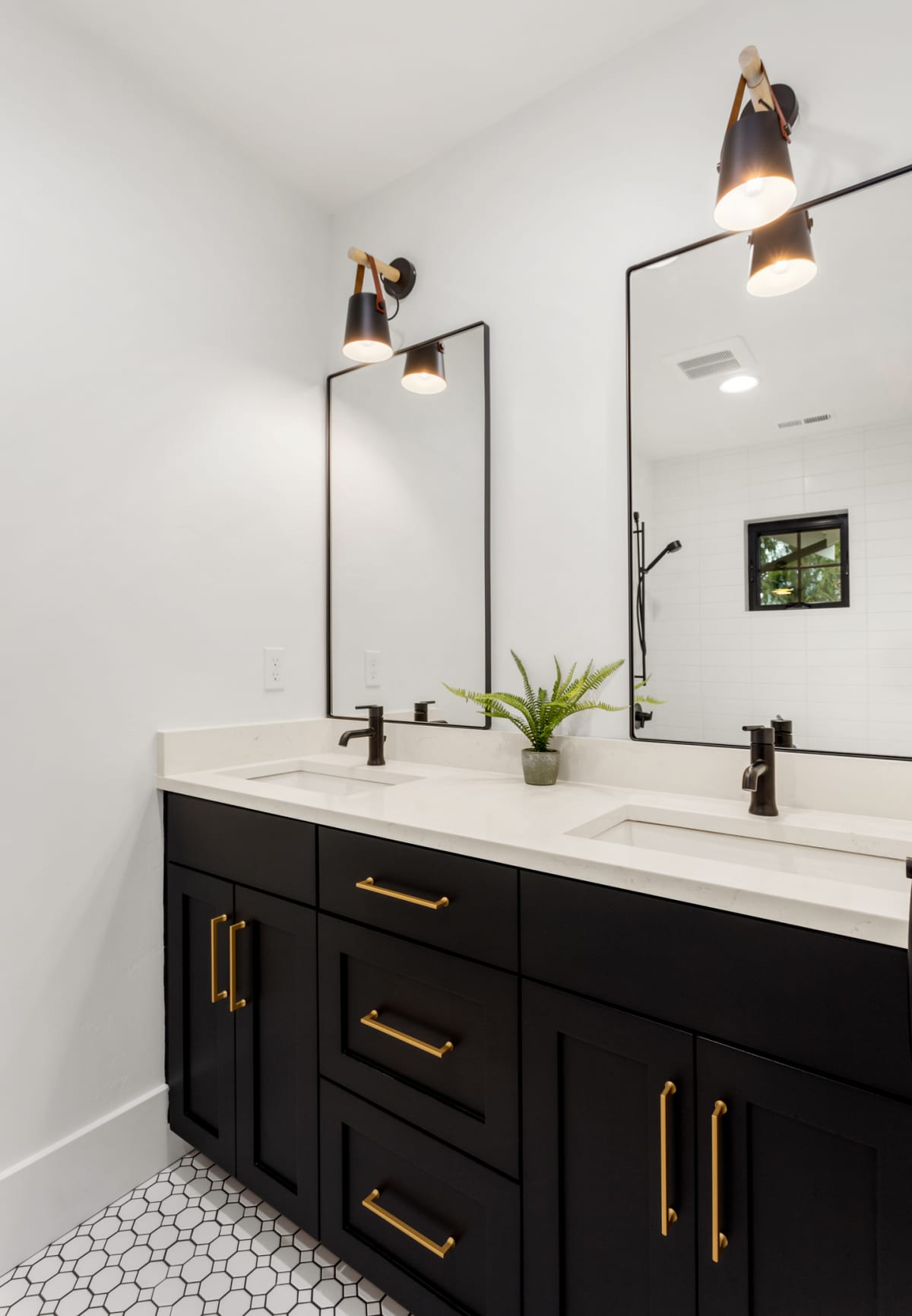 A bathroom with vanity, mirrors, and cabinets