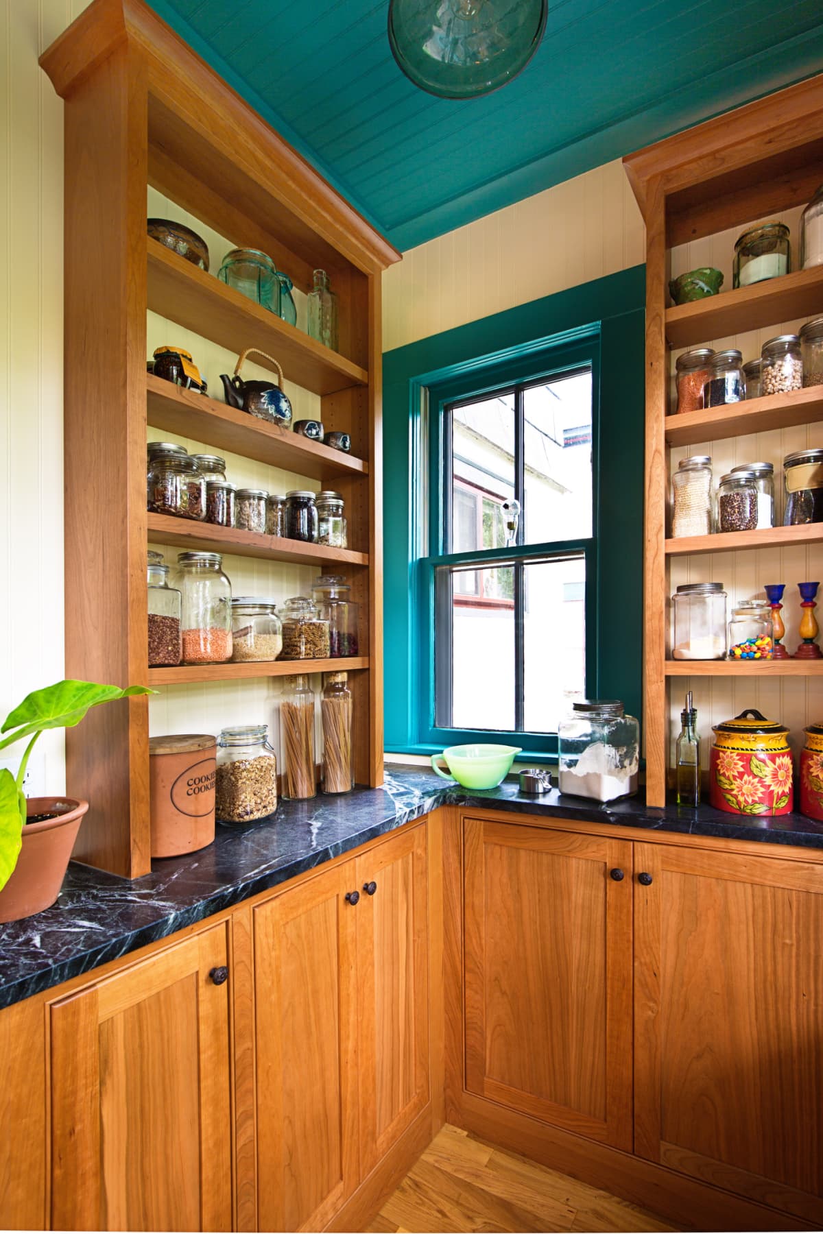 A contemporary classic kitchen renovation remodeling featuring a pantry storage shelf and maple cabinet.