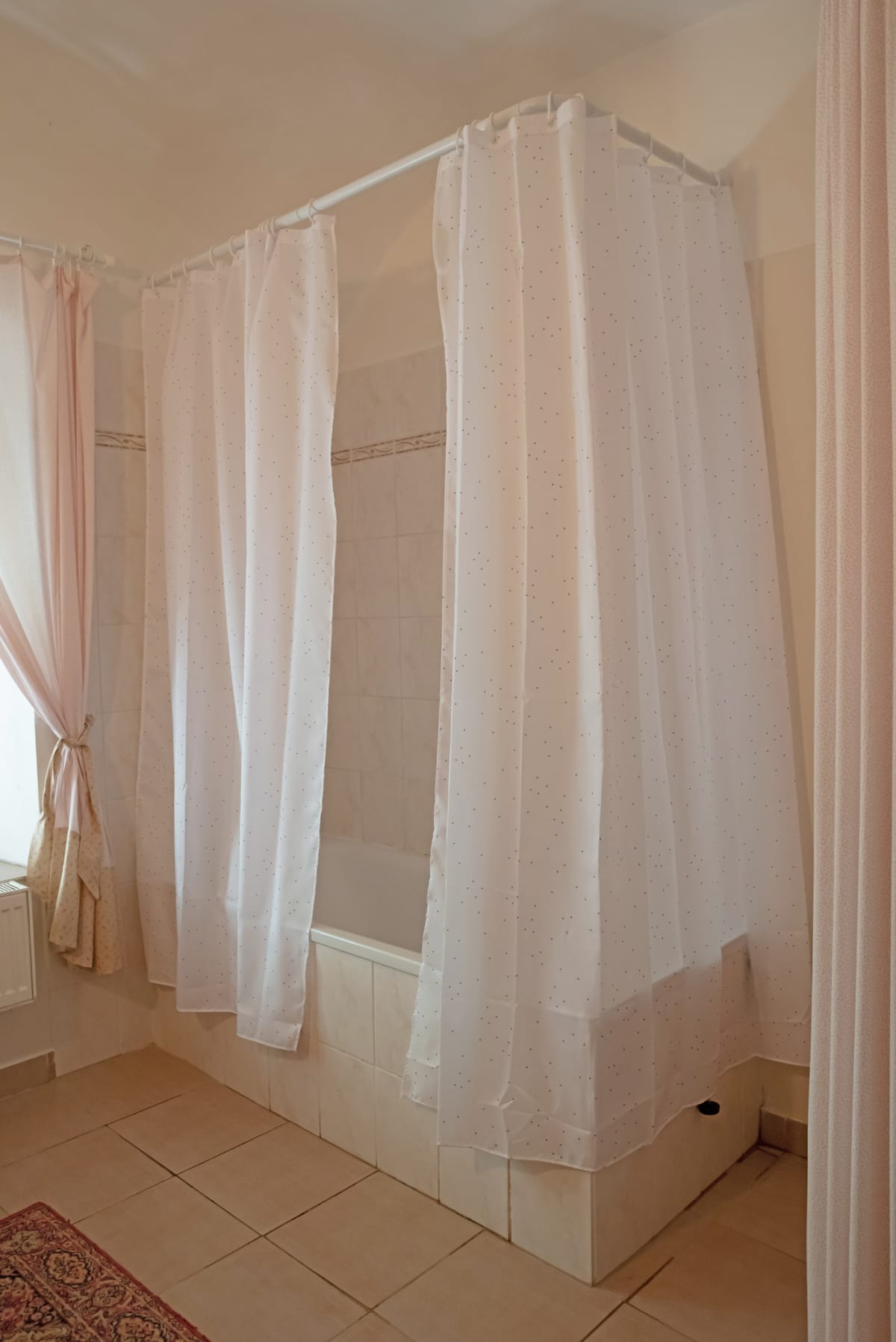 Shower curtain in an old tiled bathroom