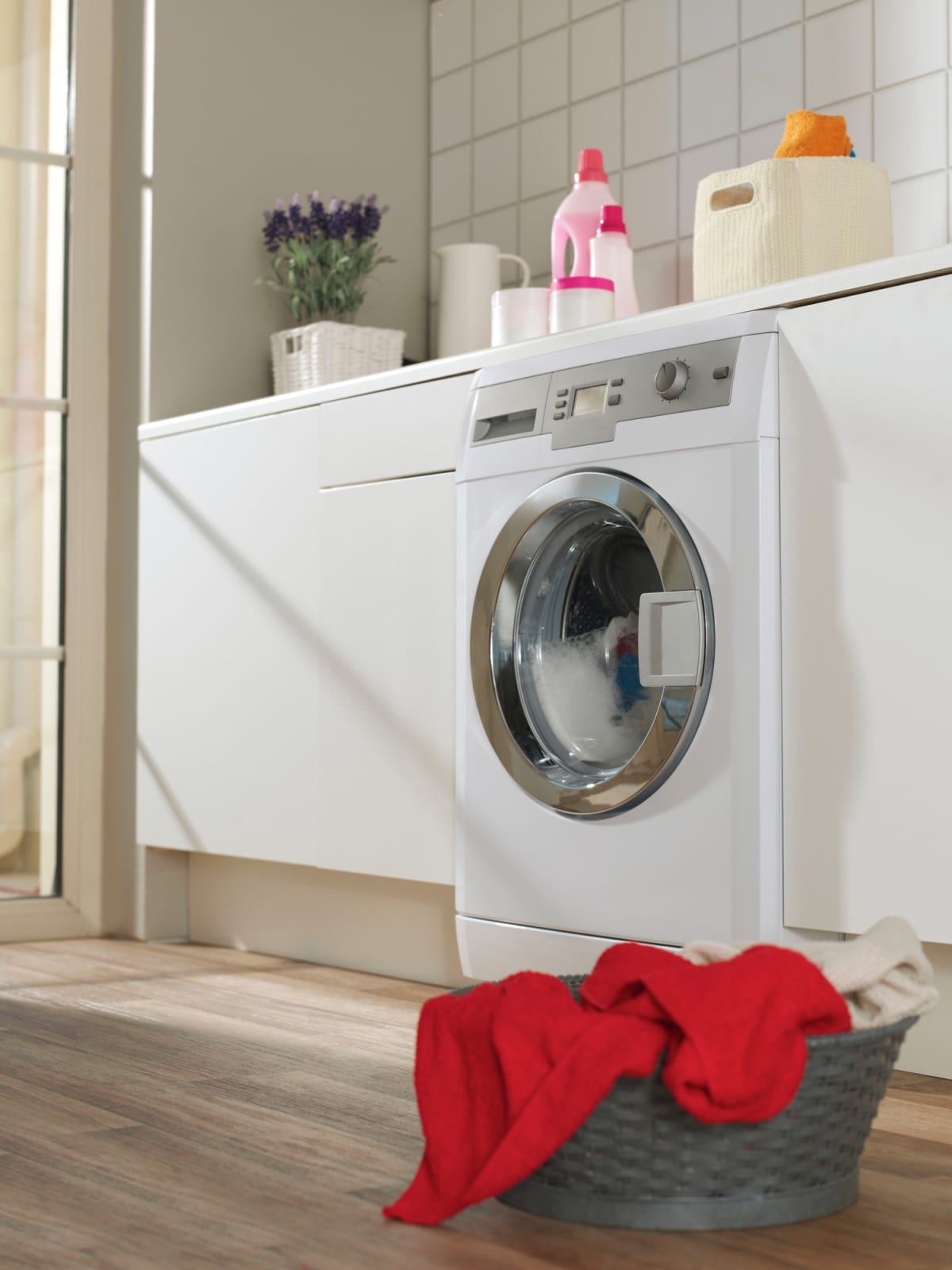 A laundry room with a washer.