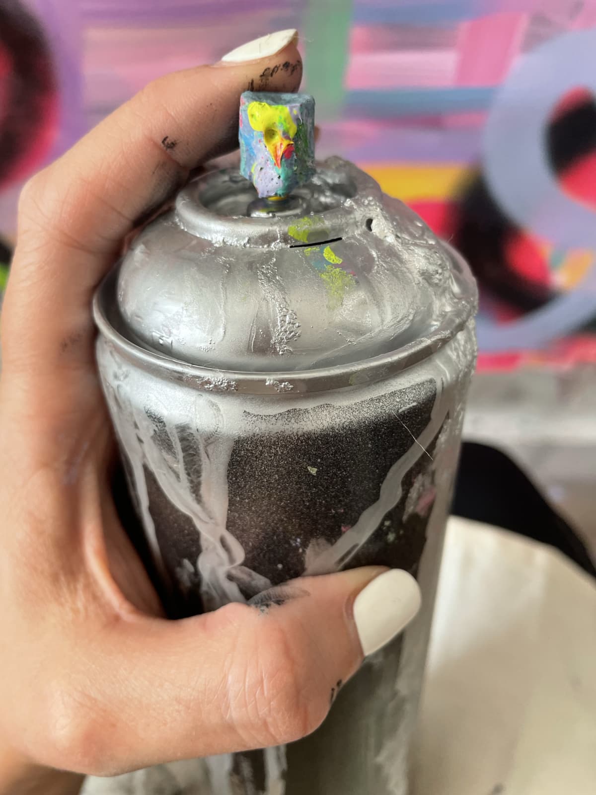 A person using a dirty can of spray paint