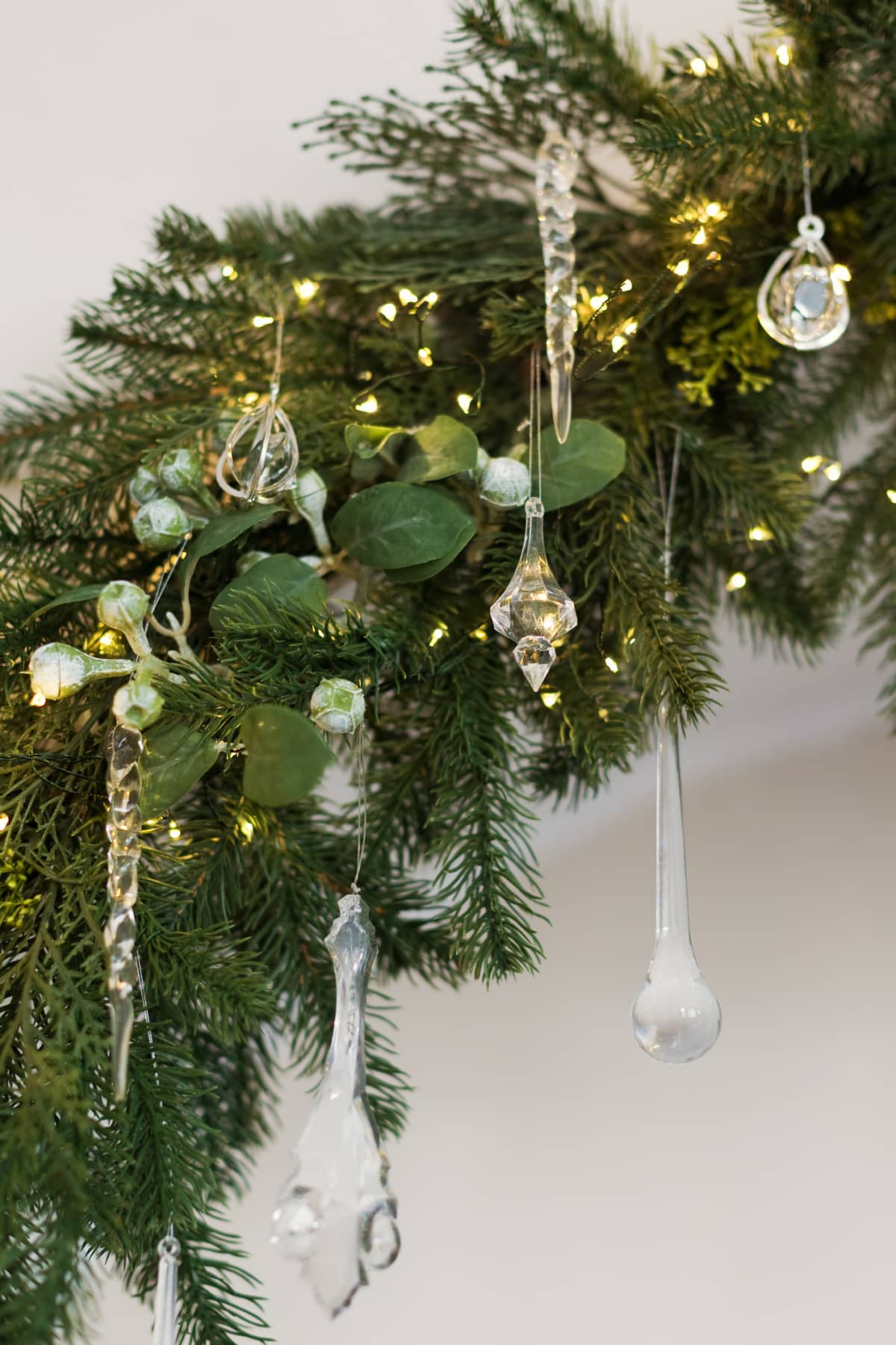 Christmas tree branch with baubles and lights