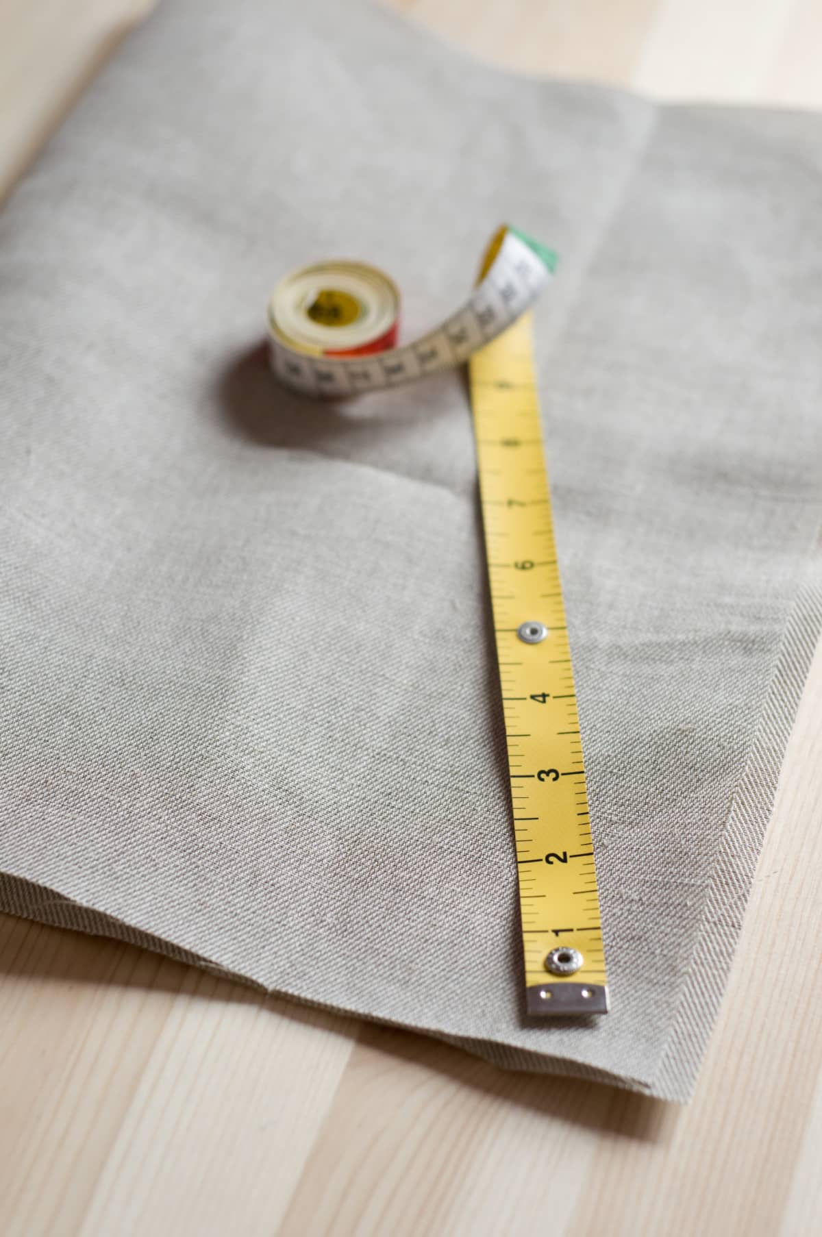 Fabric tape measure on natural colored linen.