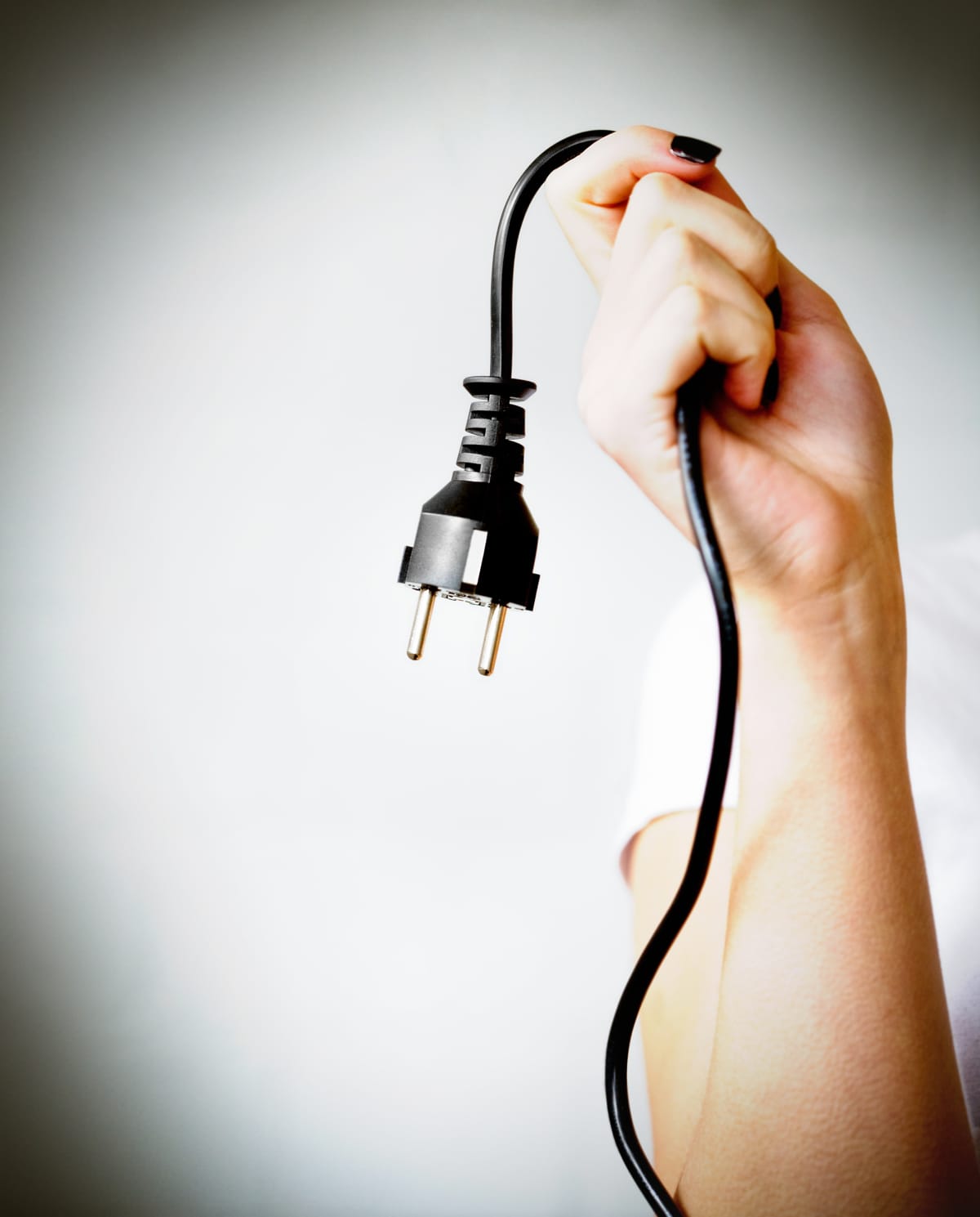 A person holding a plug cable
