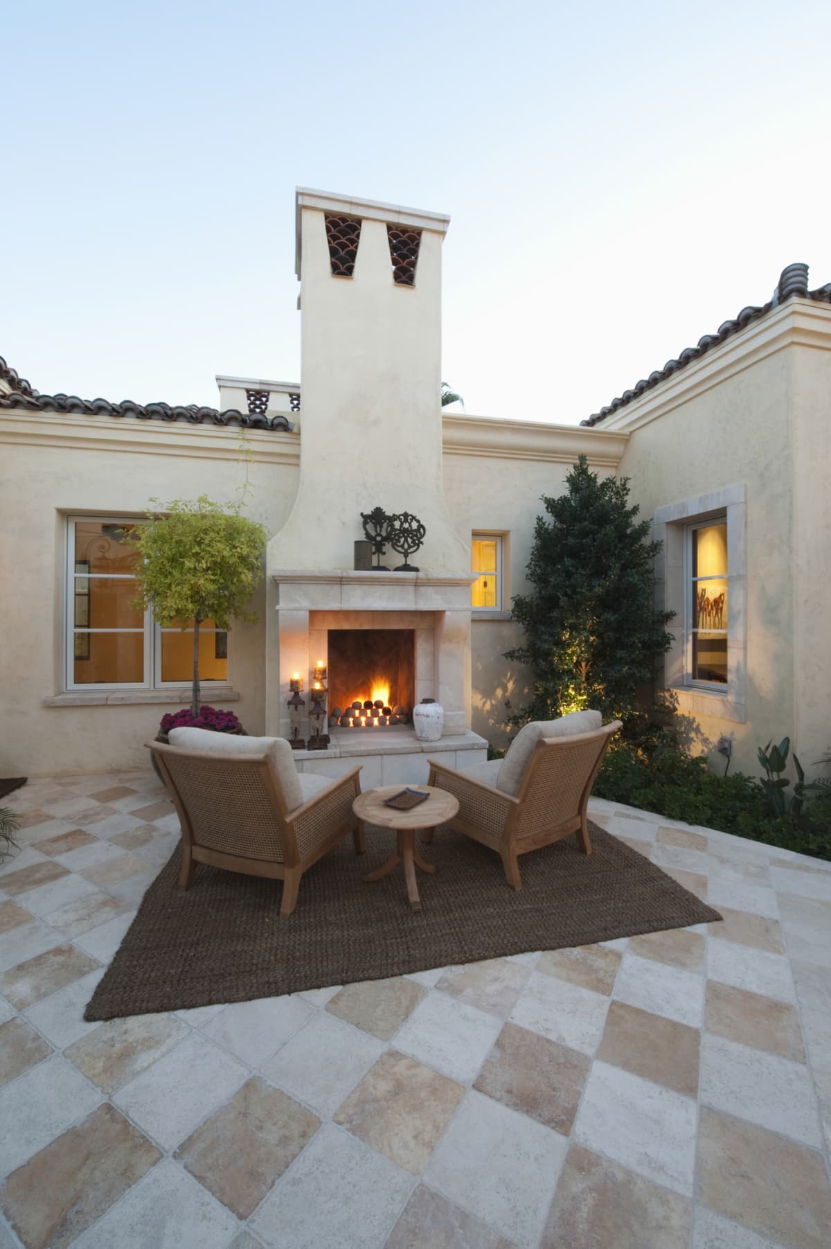 Outdoor room at dusk with fireplace and furniture
