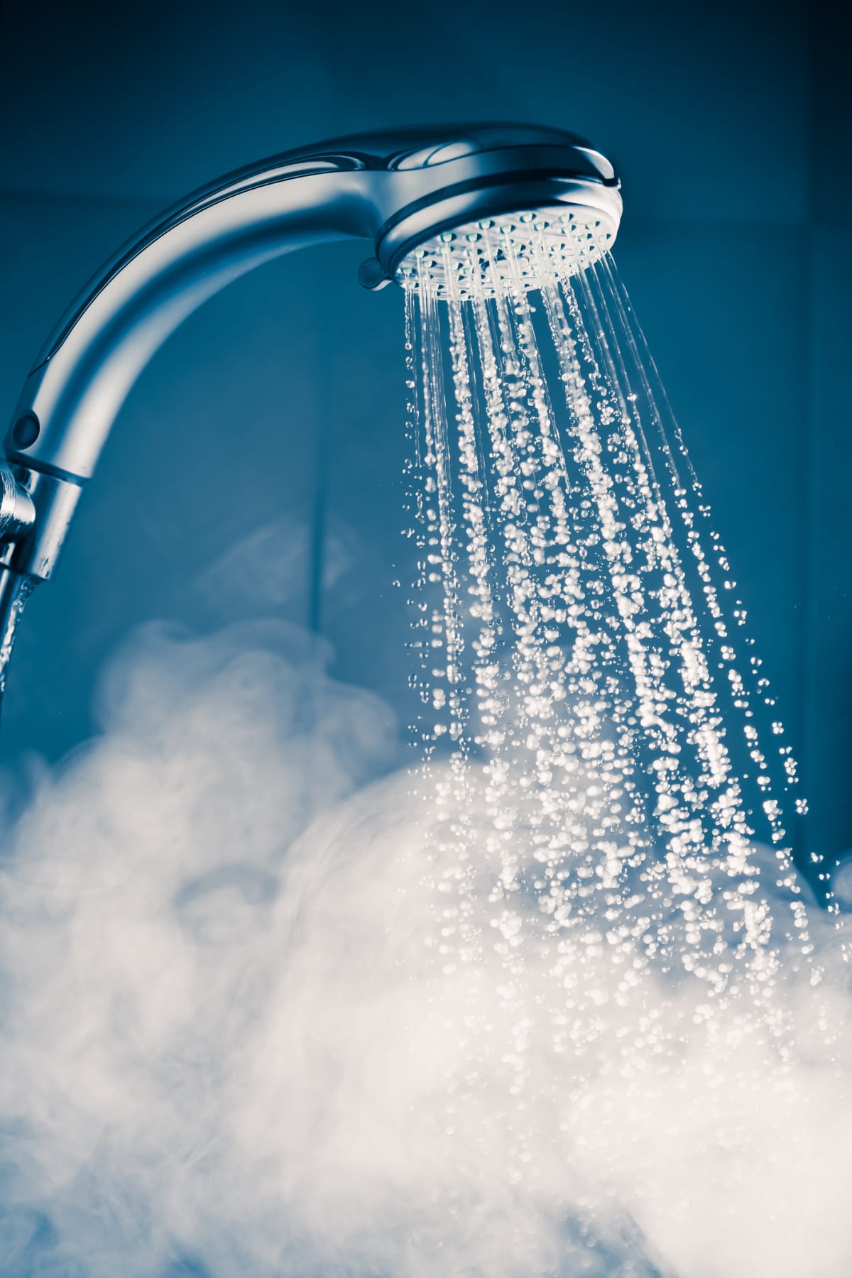 A running shower and steam against a blue background