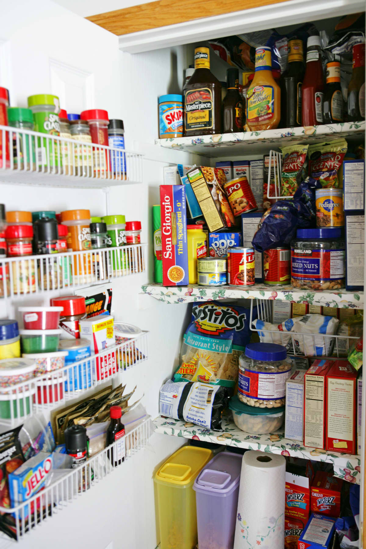 Overcrowded pantry with spice rack and cabinets