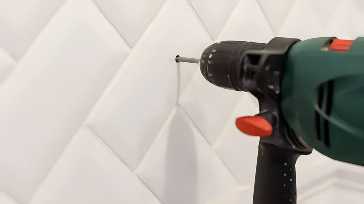 A drill drilling a hole into ceramic tile