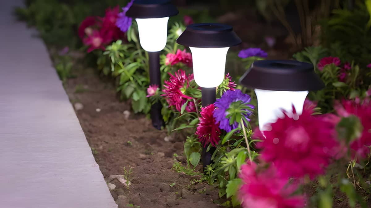outdoor lanterns in a flower bed