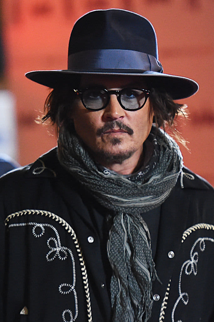FAIRFAX, VA - MAY 27: (NY & NJ NEWSPAPERS OUT) Johnny Depp gestures to his fans during a recess outside court during the Johnny Depp and Amber Heard civil trial at Fairfax County Circuit Court on May 27, 2022 in Fairfax, Virginia. Depp is seeking $50 million in alleged damages to his career over an op-ed Heard wrote in the Washington Post in 2018.(Photo by Cliff Owen/Consolidated News Pictures/Getty Images)