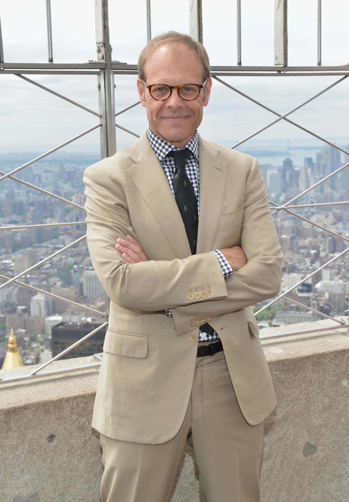 Alton brown crossing his arms and smiling