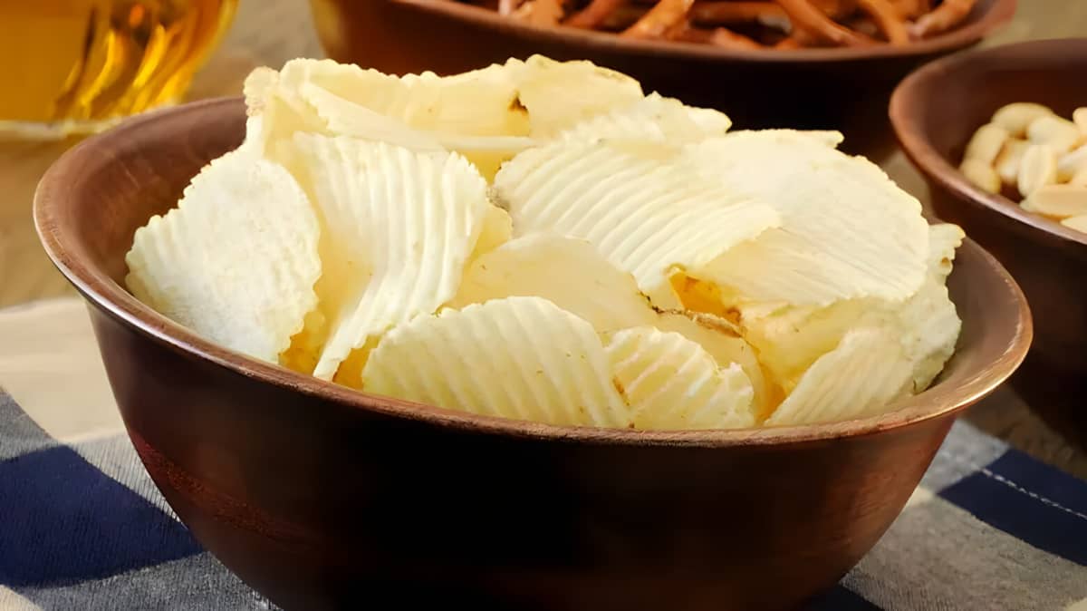 Potato chips in a brown bowl.