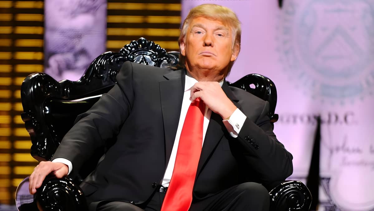 Donald Trump sitting and posing with a straight face.