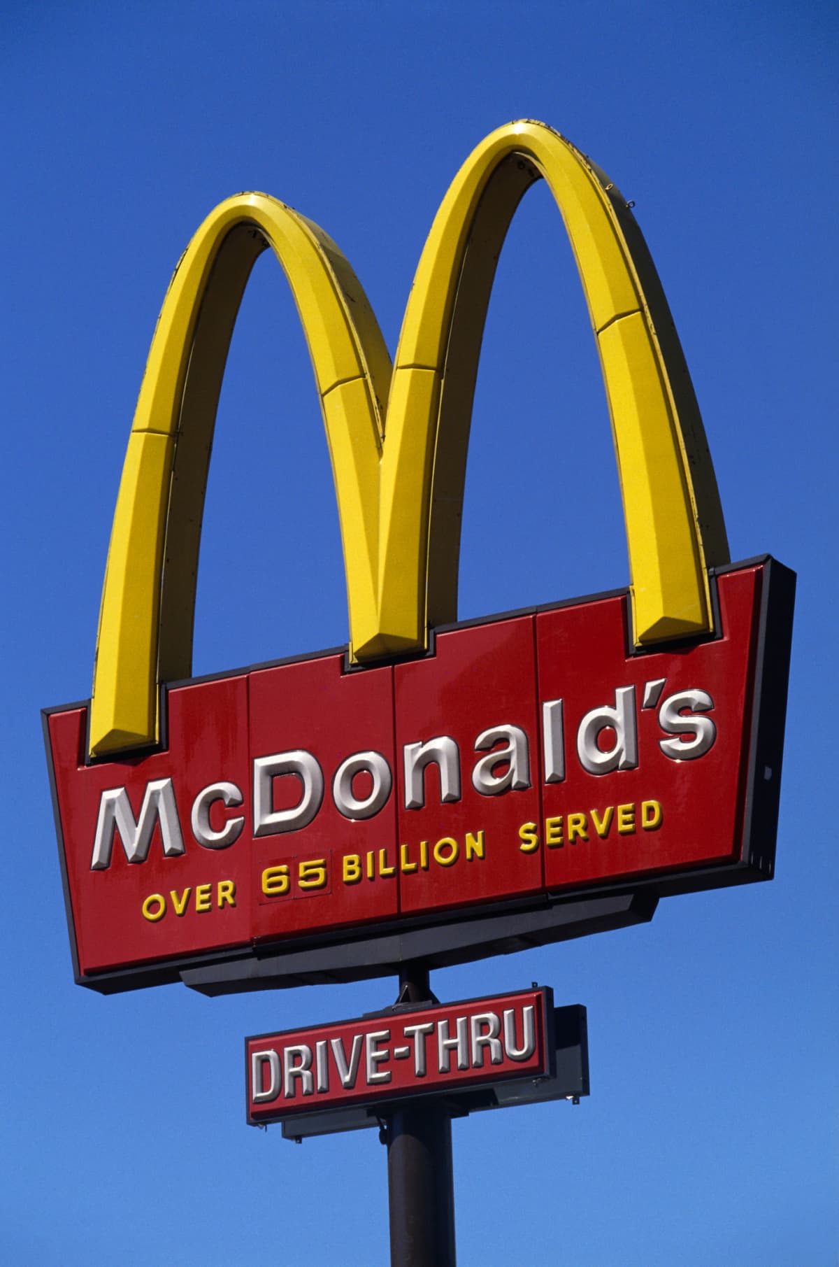 McDonald's sign in front of a blue sky.