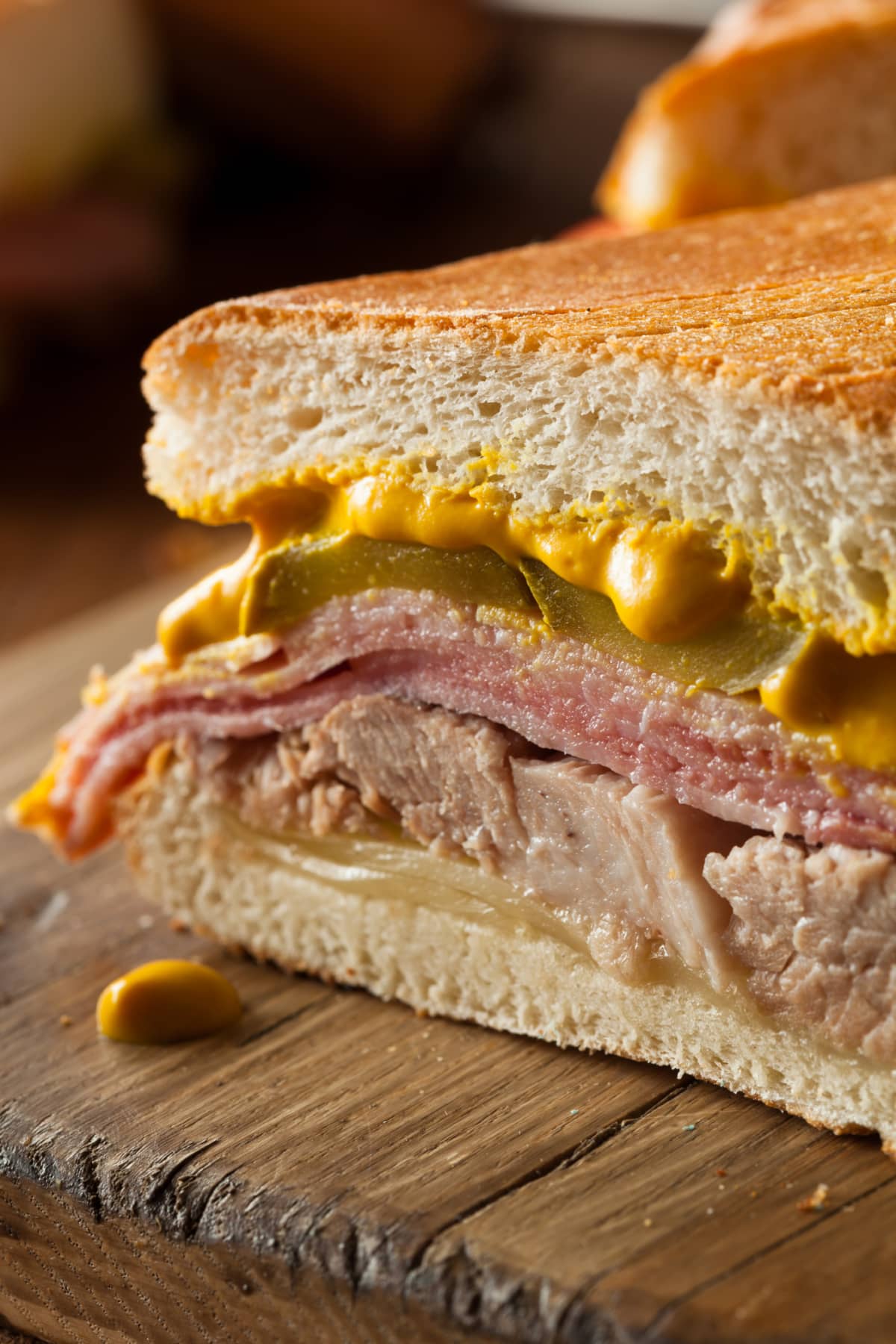 Cuban sandwich with mustard, pickles, and meat 