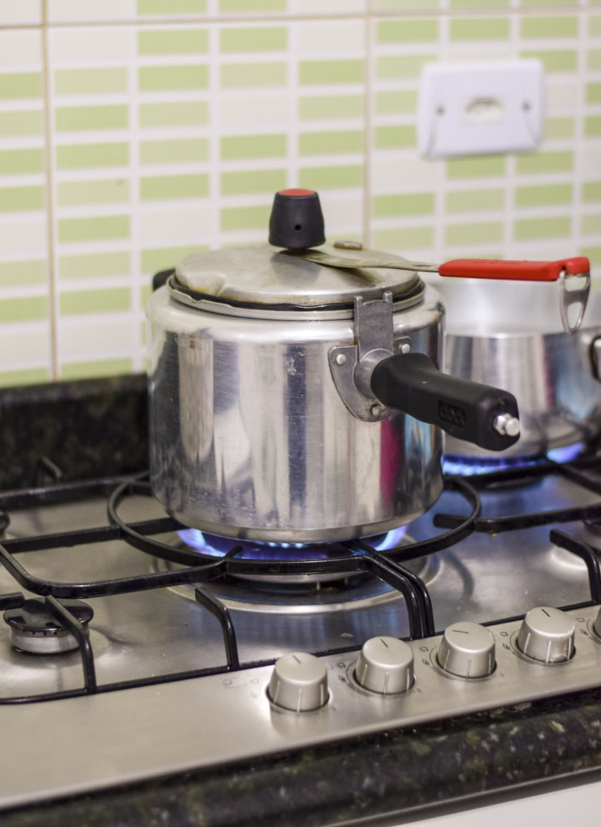Pressure cooker on a gas stove burner