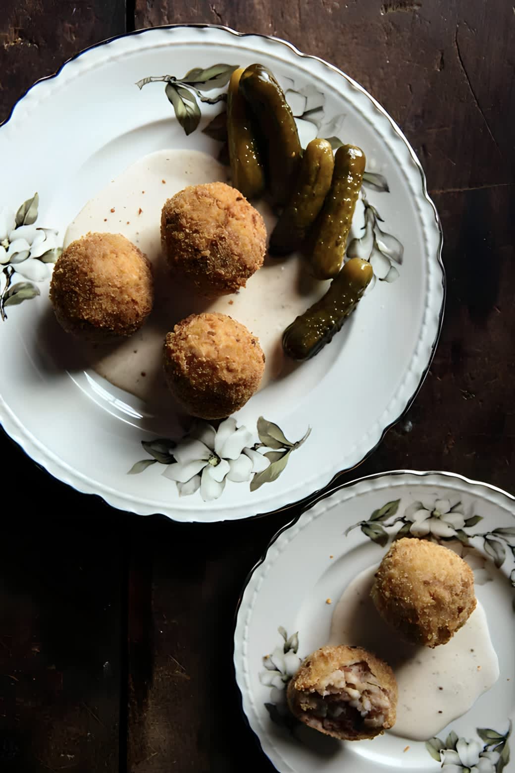 Boudin balls on a plate with sauce.