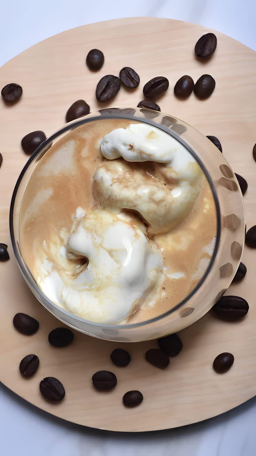 an affogato surrounded by coffee beans