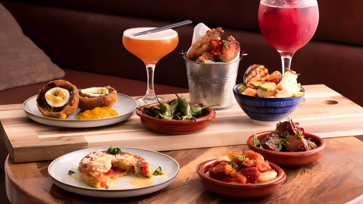 Spanish tapas next to a cocktail