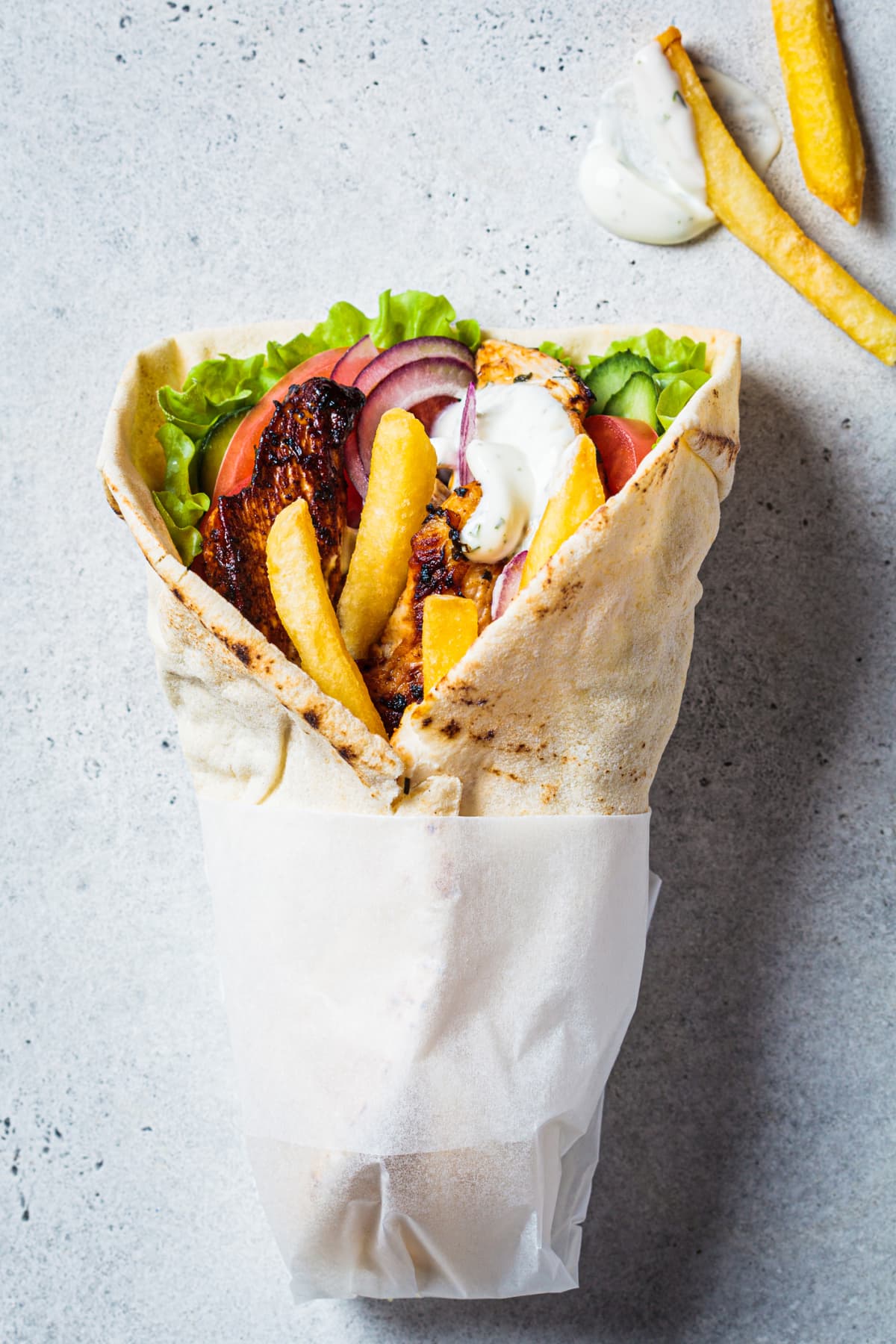 Chicken gyros with vegetables and french fries