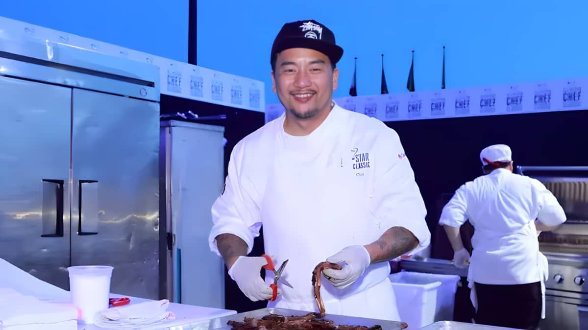 Roy Choi in the kitchen, smiling.