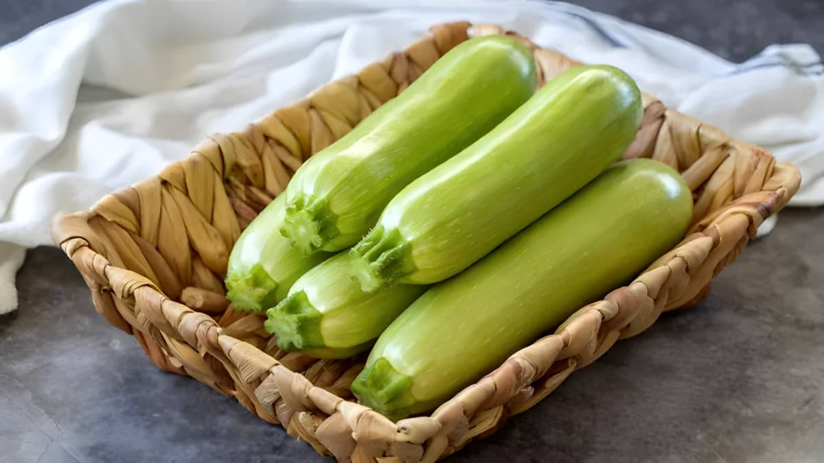 Whole zucchinis in a basket.