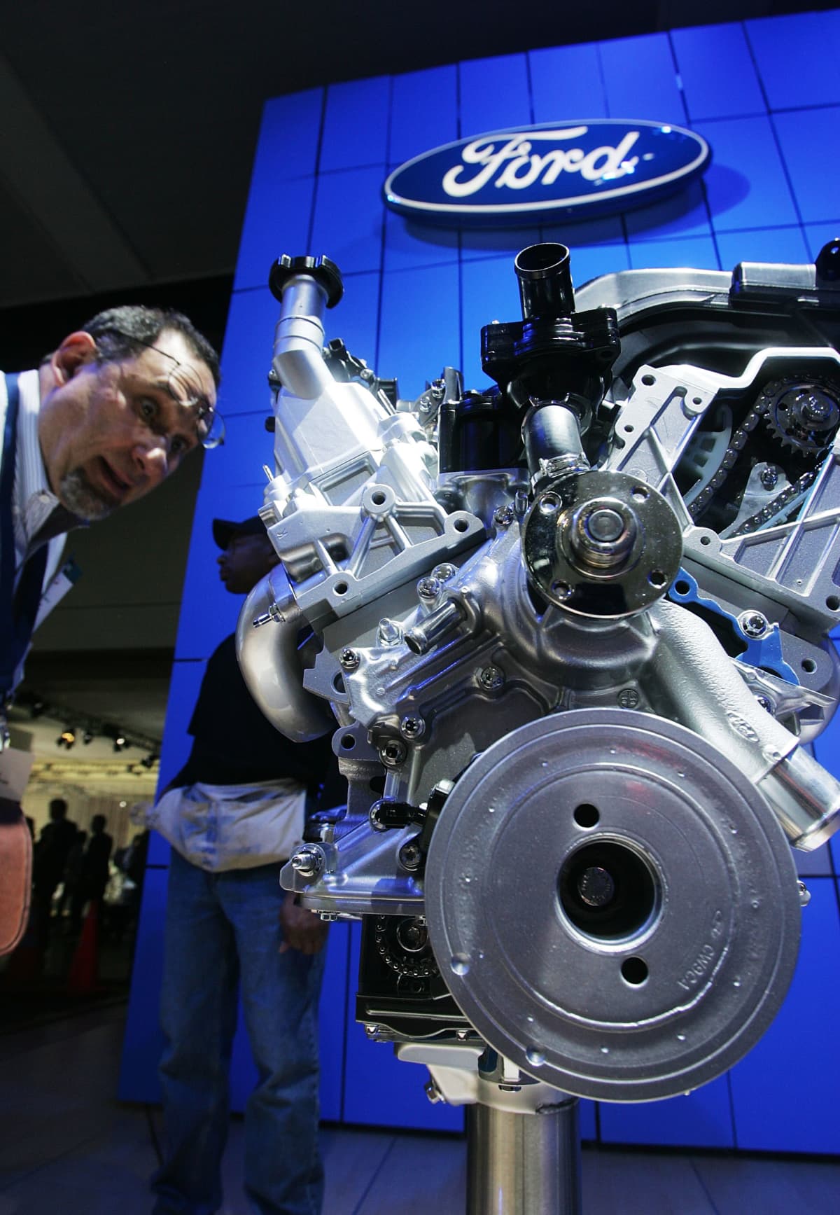NEW YORK - APRIL 04:  A man looks at a Ford 4.0-liter SOHC V-6 engine at the New York International Auto Show April 4, 2007 in New York City. The show opens to the public April 6, 2007.  (Photo by Mario Tama/Getty Images)