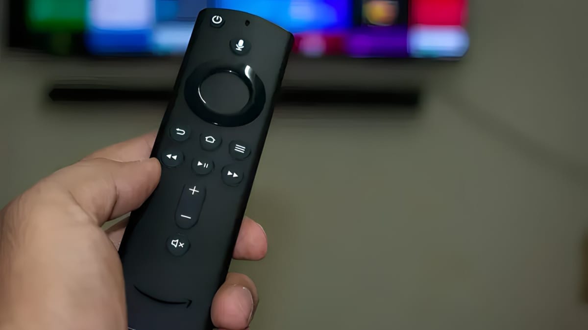 A hand holding a Amazon Firestick remote