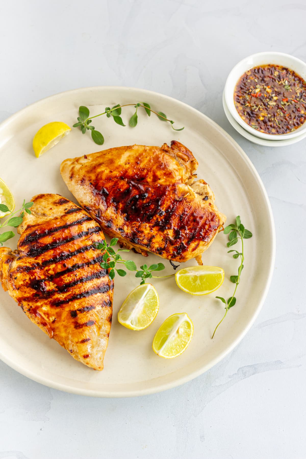Two grilled chicken breasts on a plate