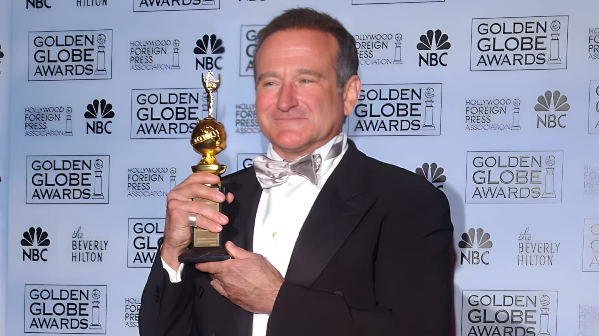 Robin Williams holding an award