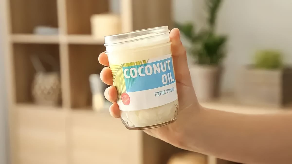 Person holding a jar of coconut oil
