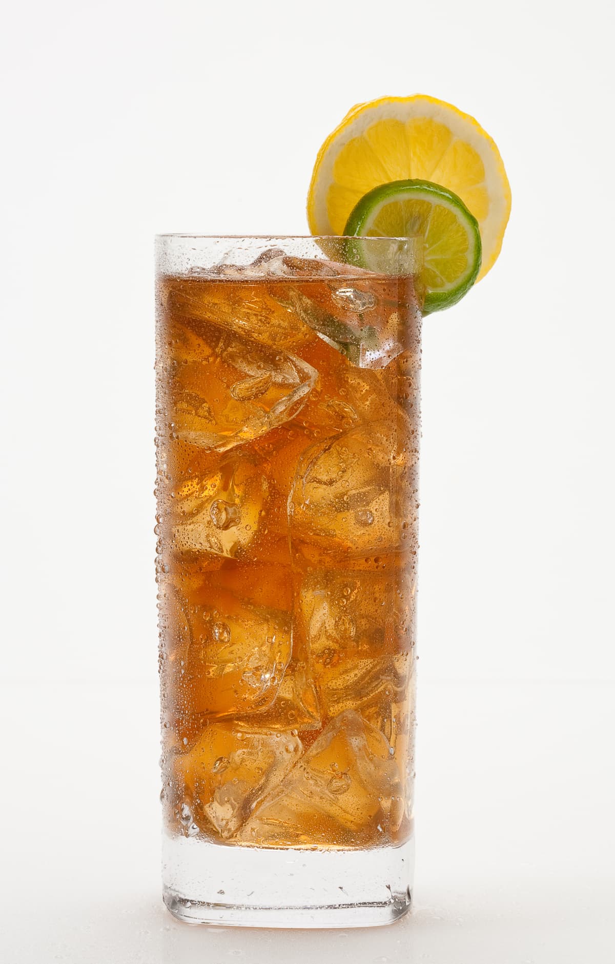 Iced Tea isolated on white background.  Droplets on glass. Larger files include clipping path. Professionally shot, color corrected, retouched, exported 16 bit and silhouetted for maximum image quality.