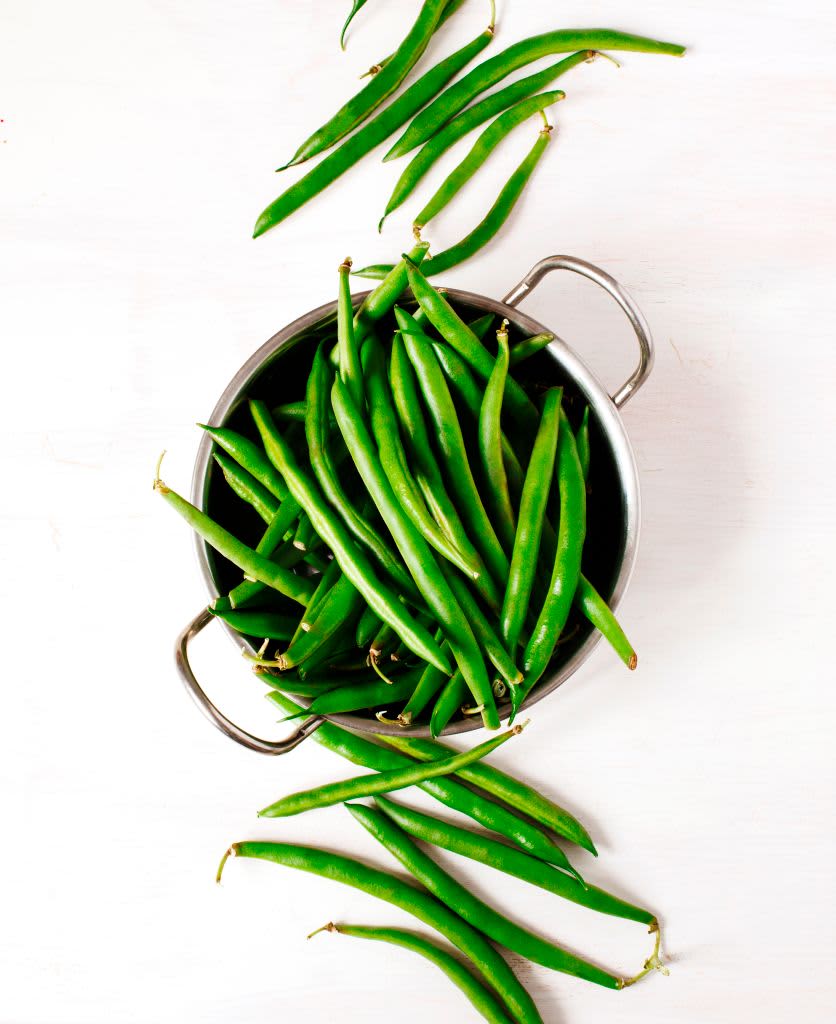 Green beans in bowl on white wooden background. top view. (Photo by: Anjelika Gretskaia/REDA&CO/Universal Images Group via Getty Images)
