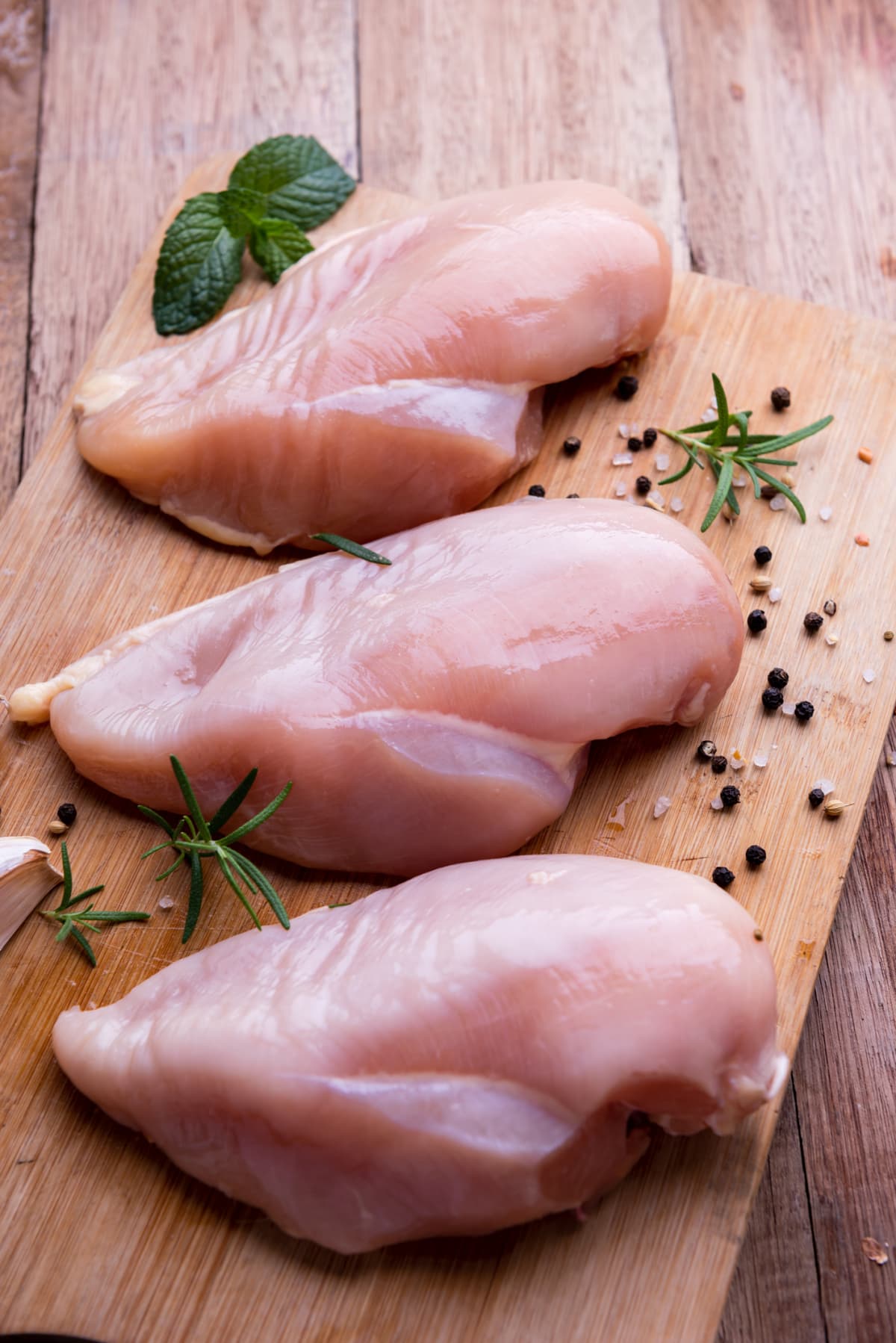 Raw chicken breasts with rosemary and spices