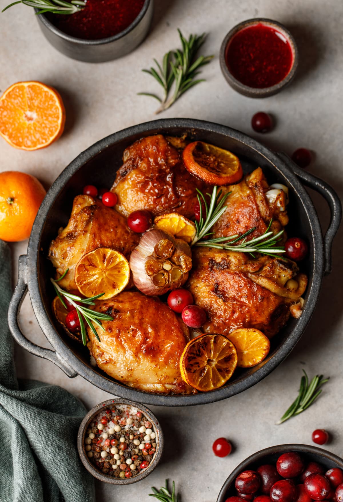 A pan of crispy chicken with citrus fruit and tomato sauce.